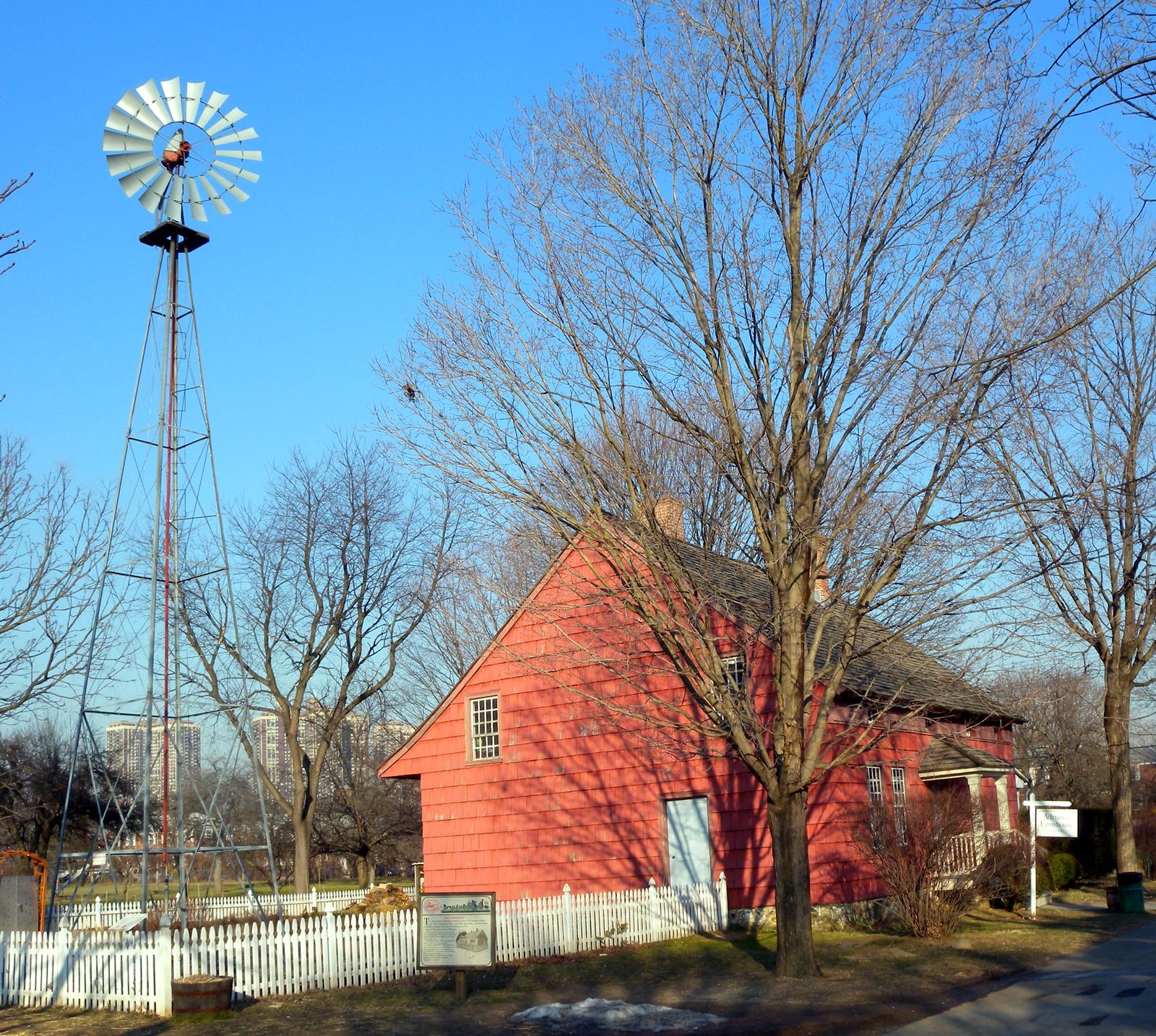 Historic red Adriance Farmhouse and windmill at Queens County Farm Museum