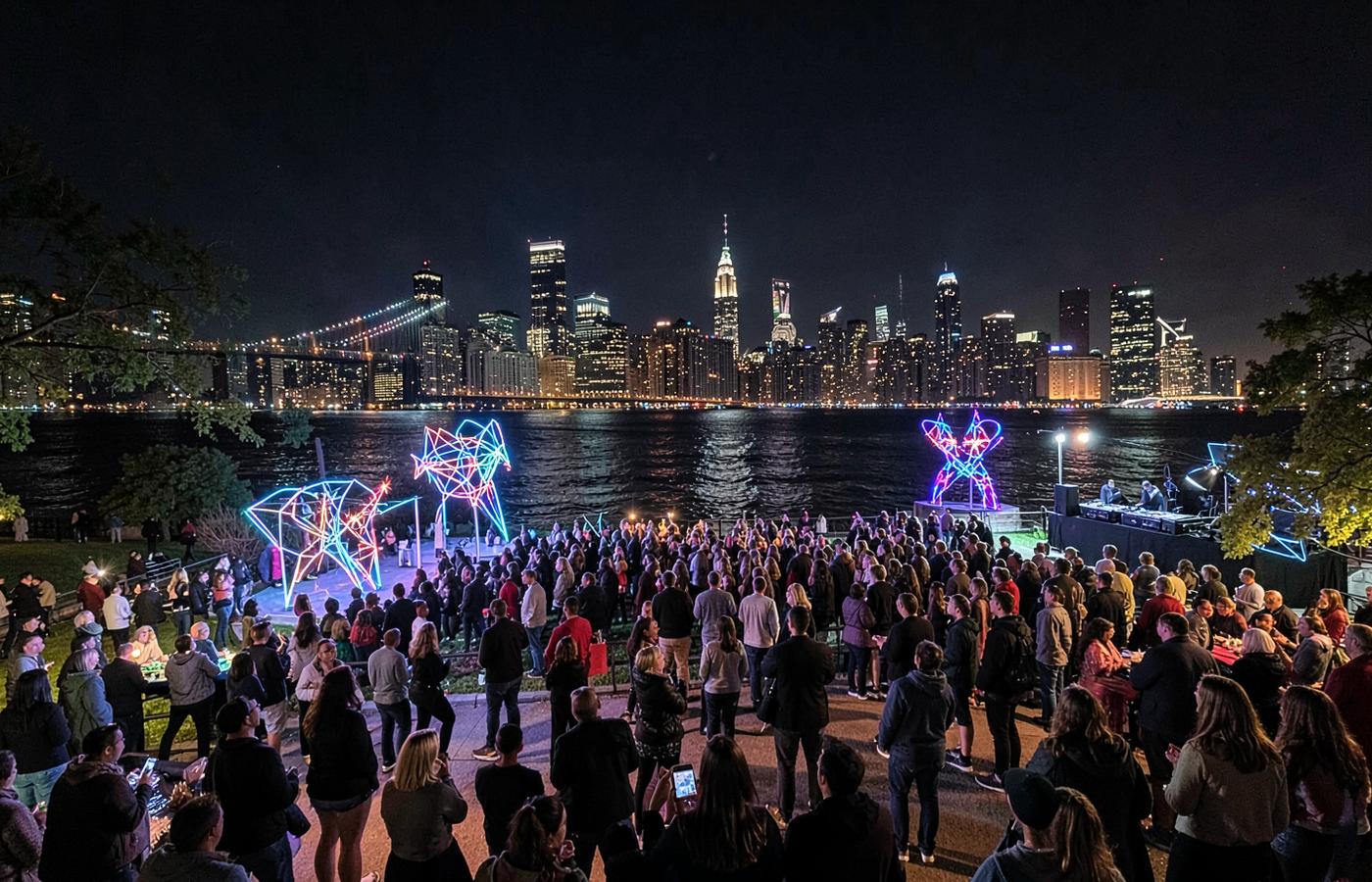 Interactive light installations and a nighttime waterfront crowd at a New York park