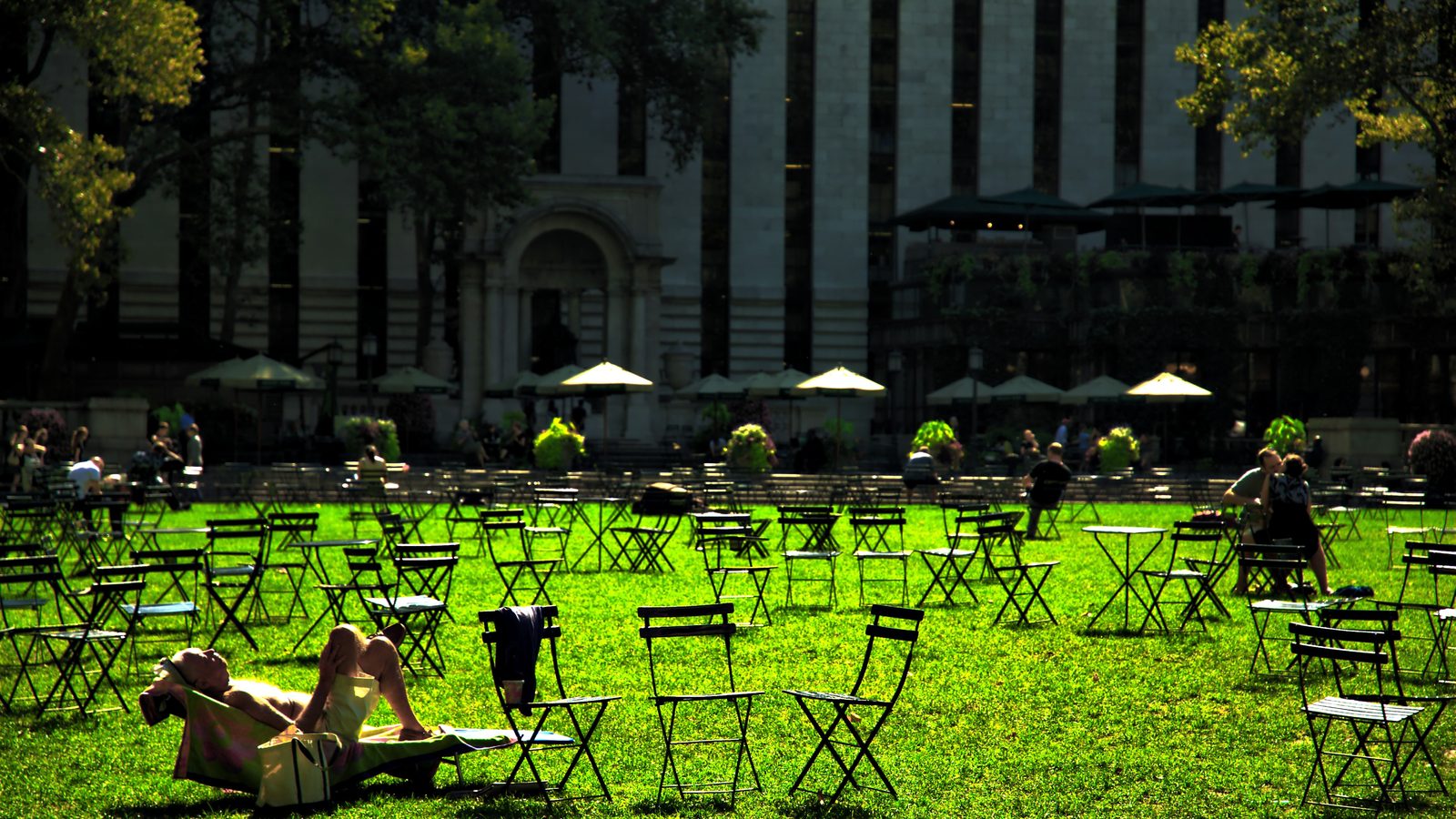 People sitting on the lawn at Bryant Park in Midtown Manhattan